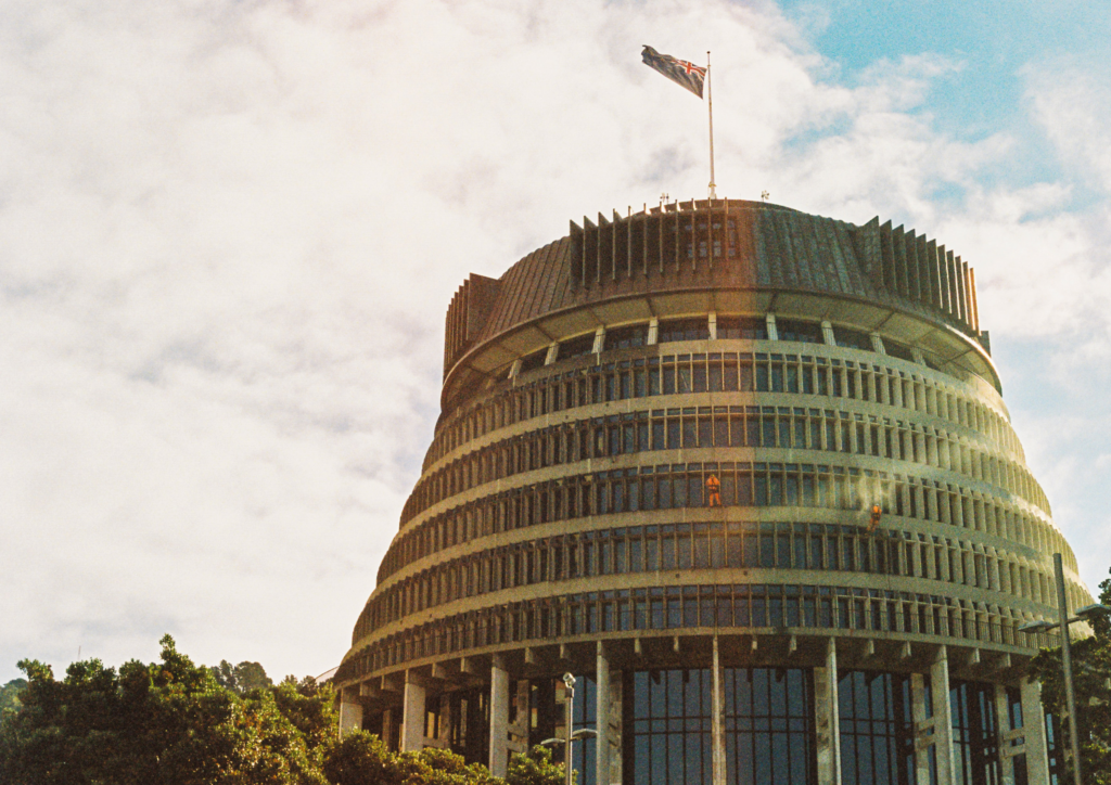 A long shot of the Beehive, the New Zealand parliament building in Wellington, the capital of Aotearoa, where legislation is made.